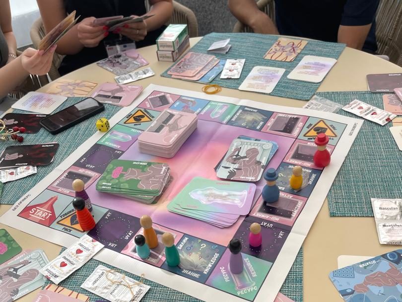 three young people playing a board game